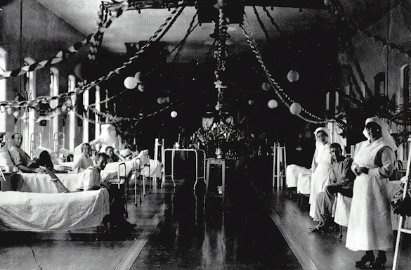 A dedicated hospital doctor attentively reviewing patient charts in a busy ward.
