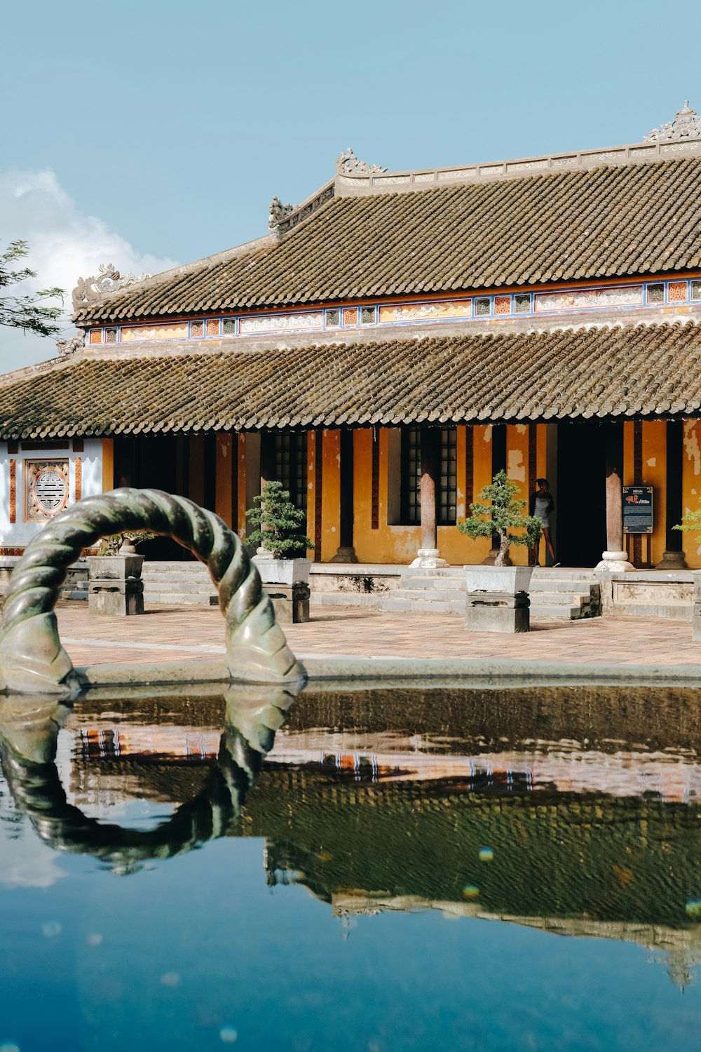 a building with a pond in front of it