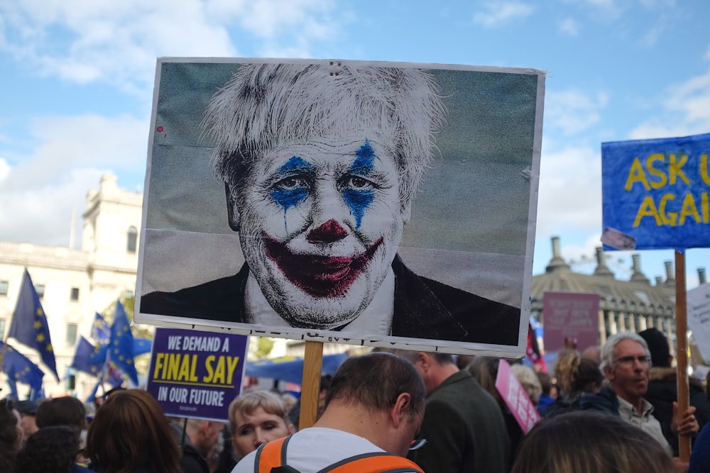 persona che tiene l'uomo che indossa l'arte del viso del clown