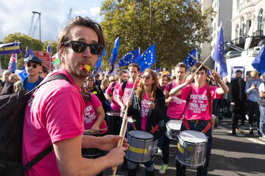 A vibrant scene from a public awareness walk with participants wearing rose-colored shirts.