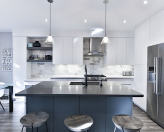 a kitchen with a center island with stools