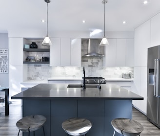 a kitchen with a center island with stools