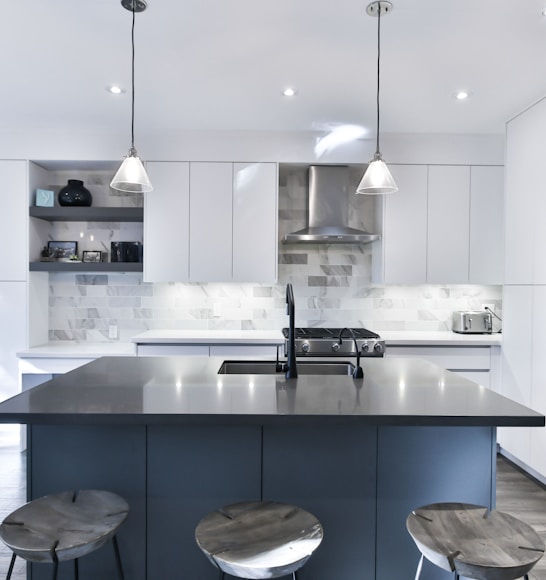 a kitchen with a center island with stools