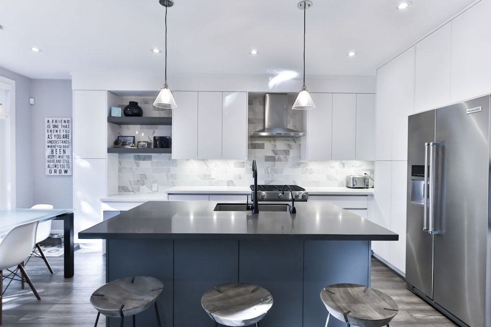 a kitchen with a center island with stools