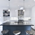 a kitchen with a center island with stools