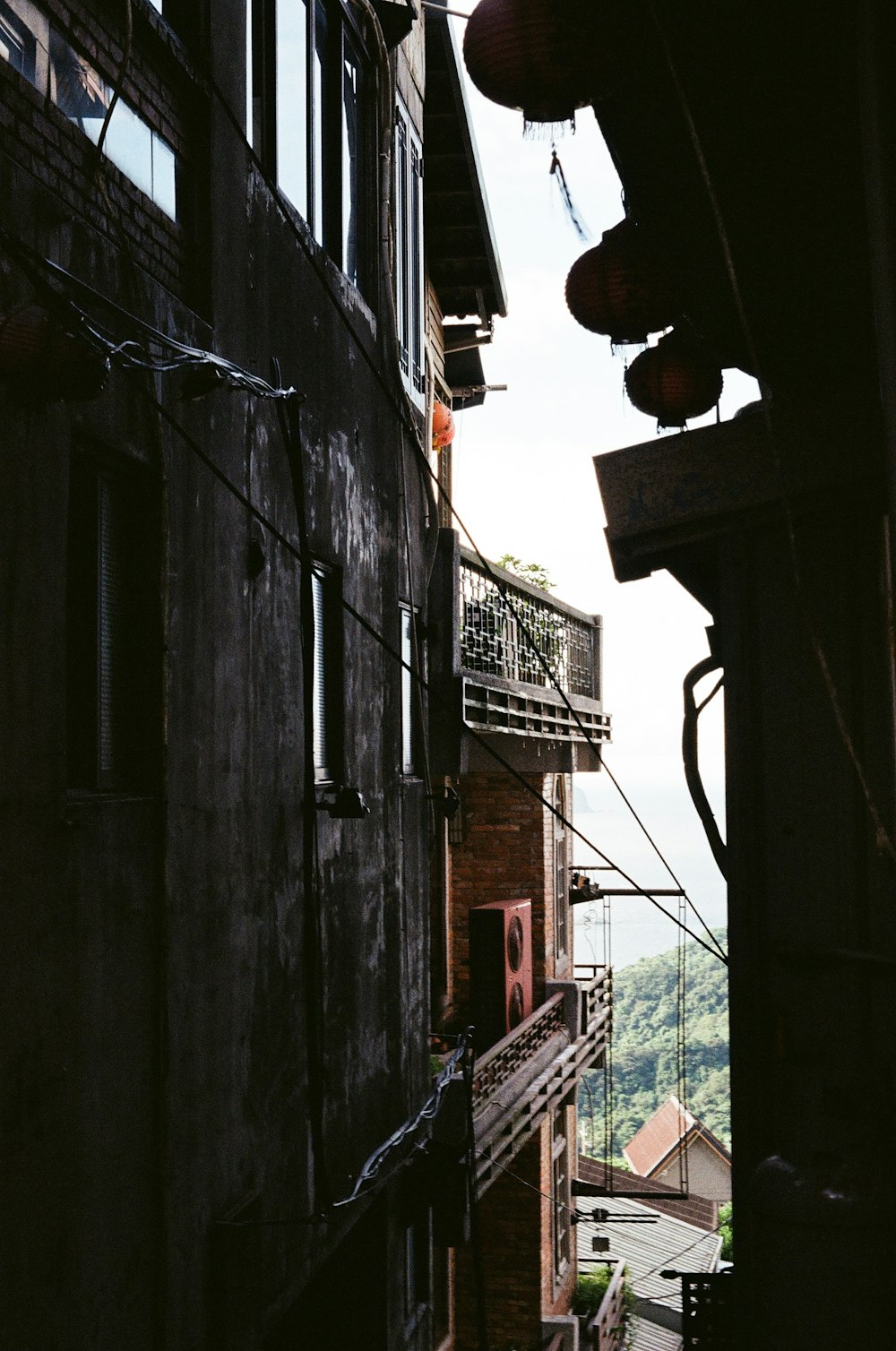 a narrow alley way with a clock on the side of the building