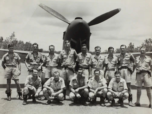 A high-resolution photo of veterans in uniform sharing a moment of camaraderie during a paratrooper reunion.