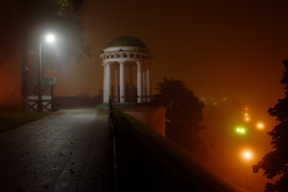 a foggy night in a park with a gazebo