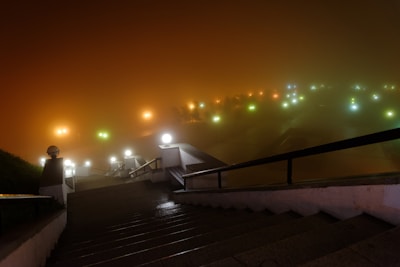 A dramatic dungeon entrance glowing with eerie green light at dusk