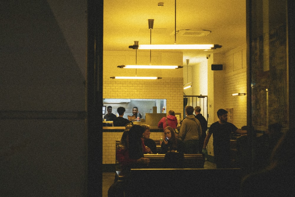 a group of people standing in a hallway