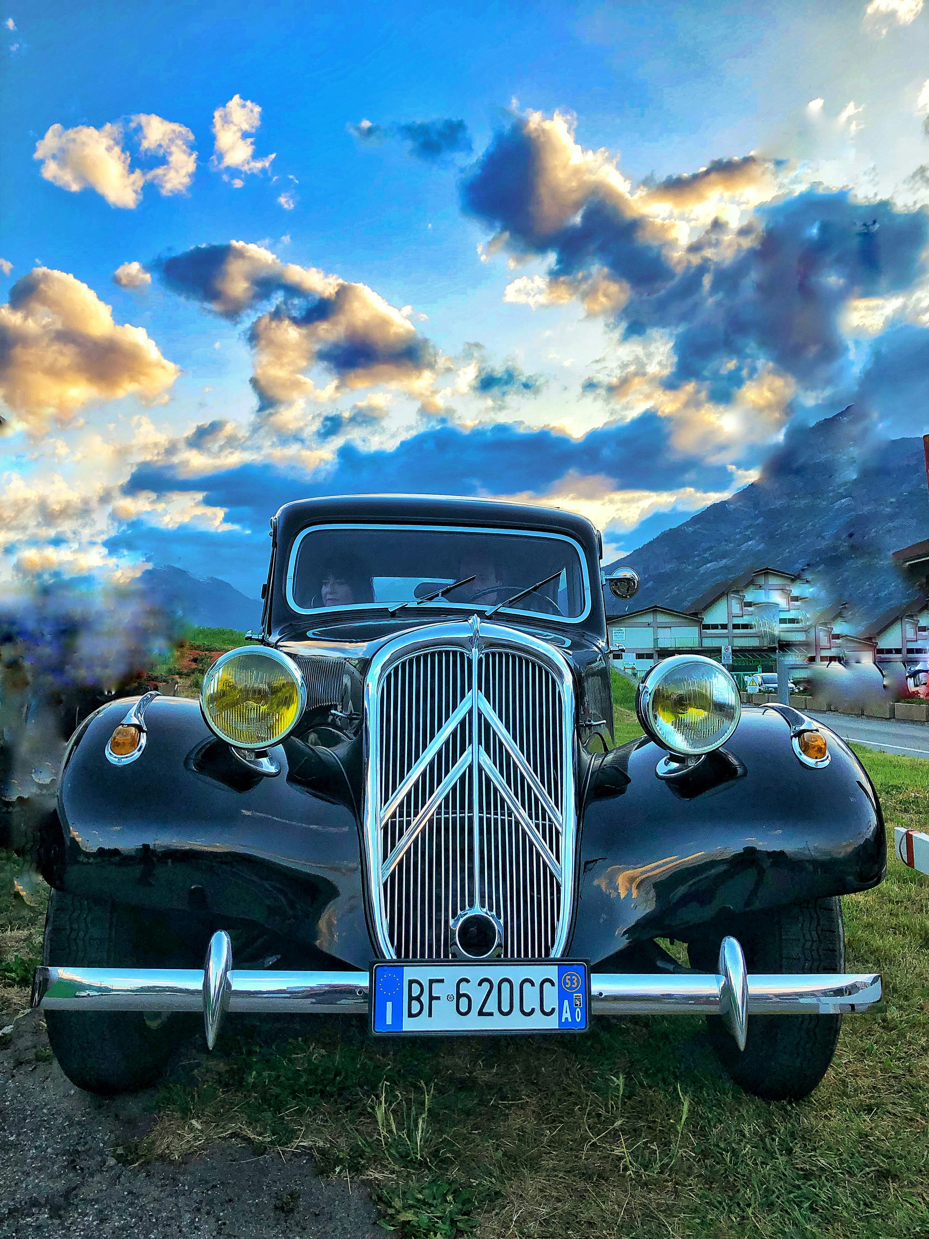 a classic car is parked in a field