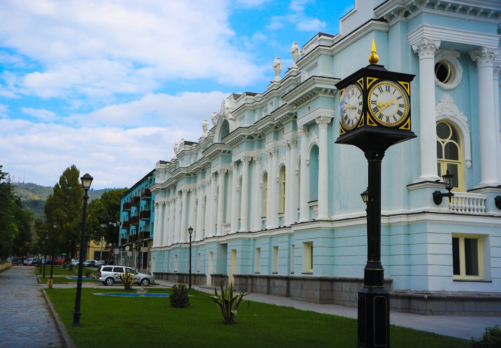 a clock on a pole in front of a building