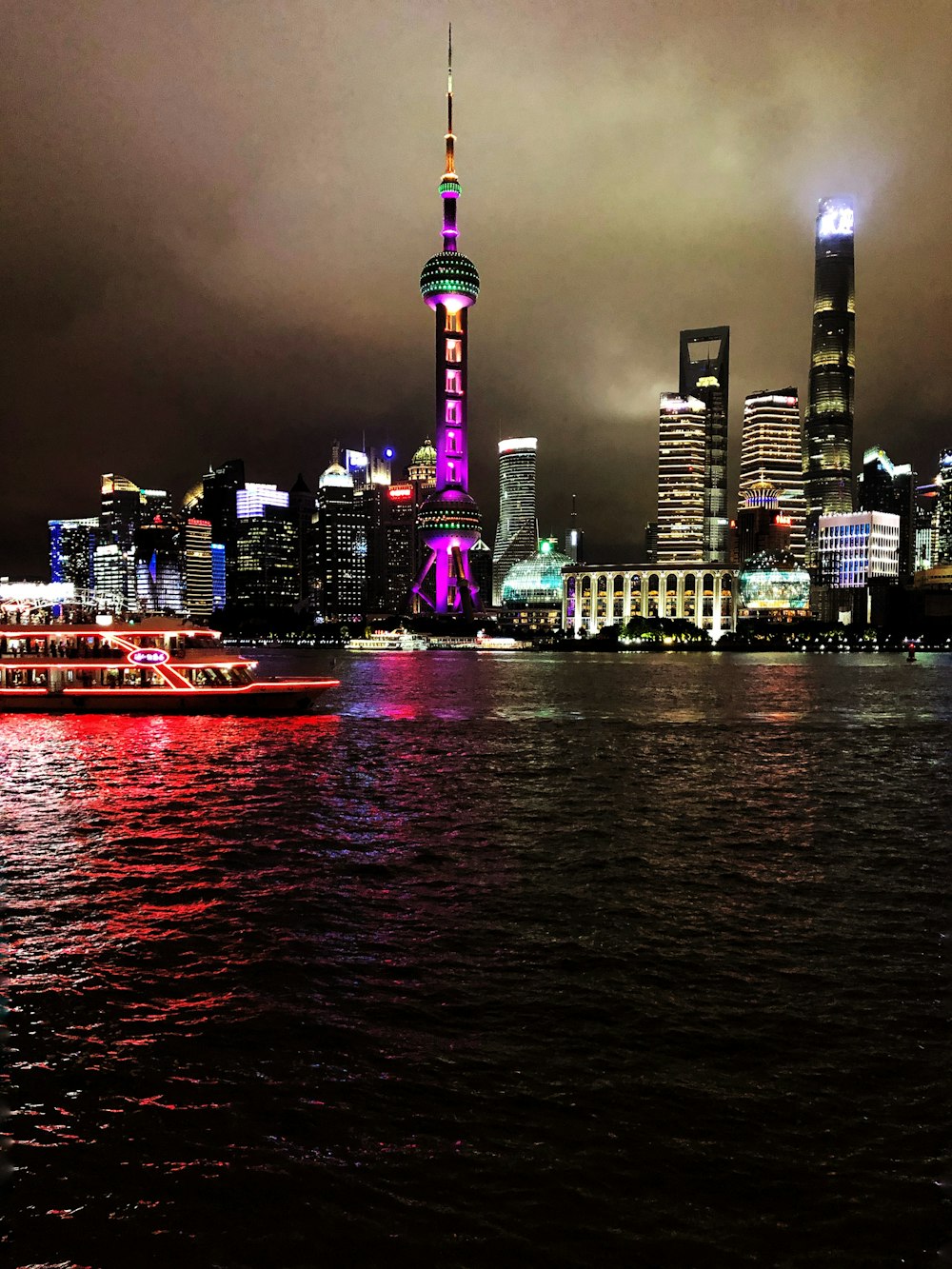 a boat is in the water in front of a city