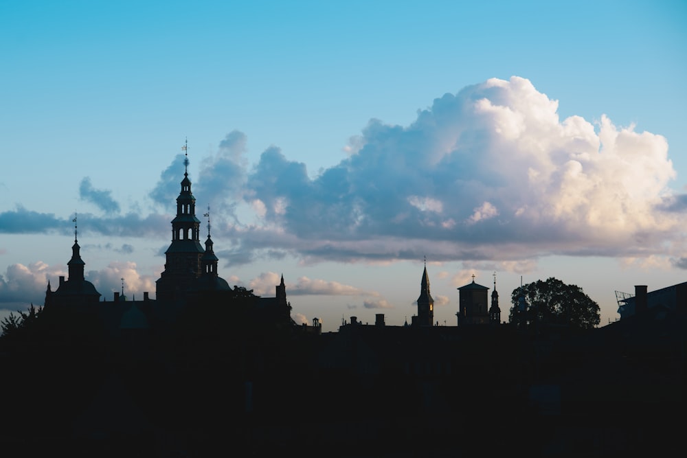 a view of a city skyline with a cloud in the sky