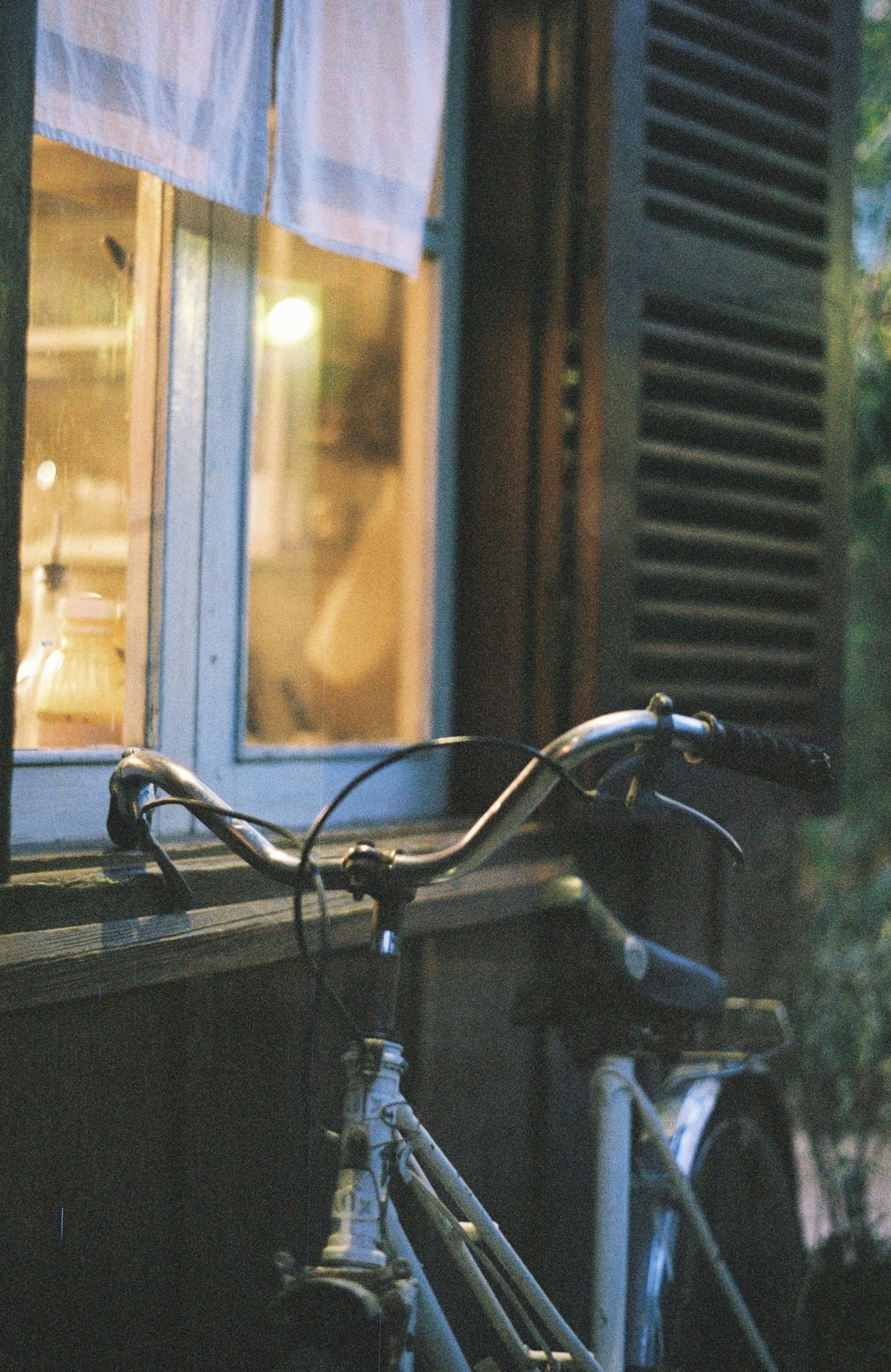 gray bicycle leaning on window pane