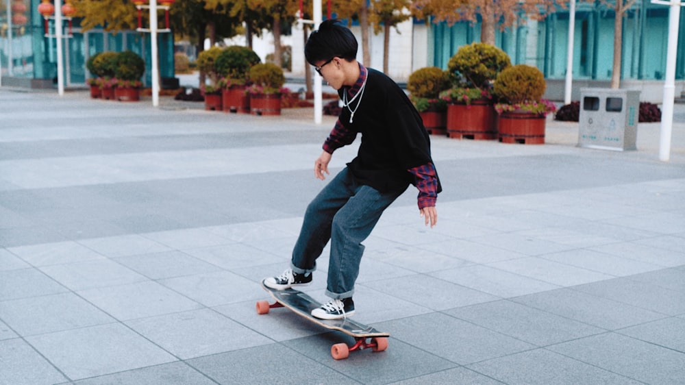 man wearing black sweater riding skateboard