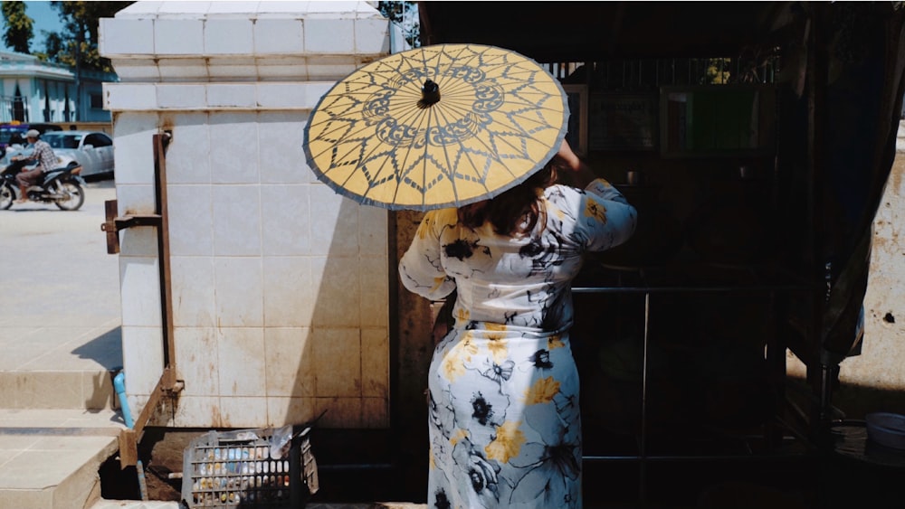 a woman holding an umbrella over her head