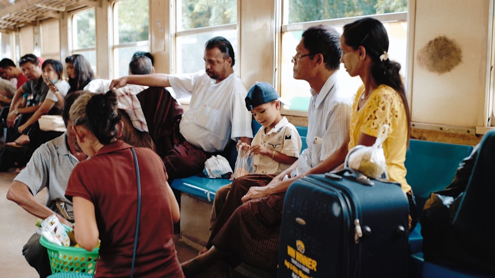 a group of people sitting next to each other on a train