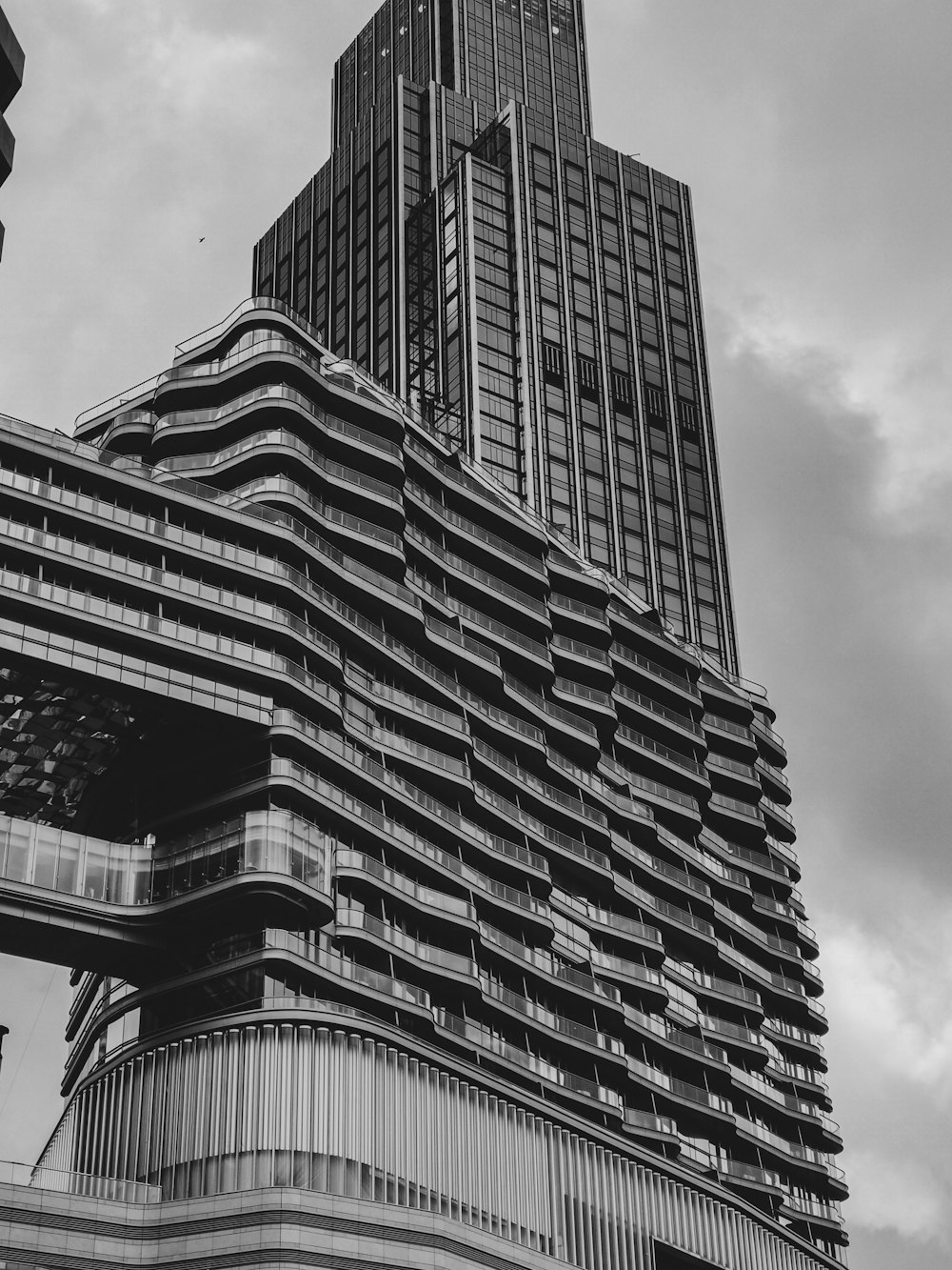 a black and white photo of a very tall building