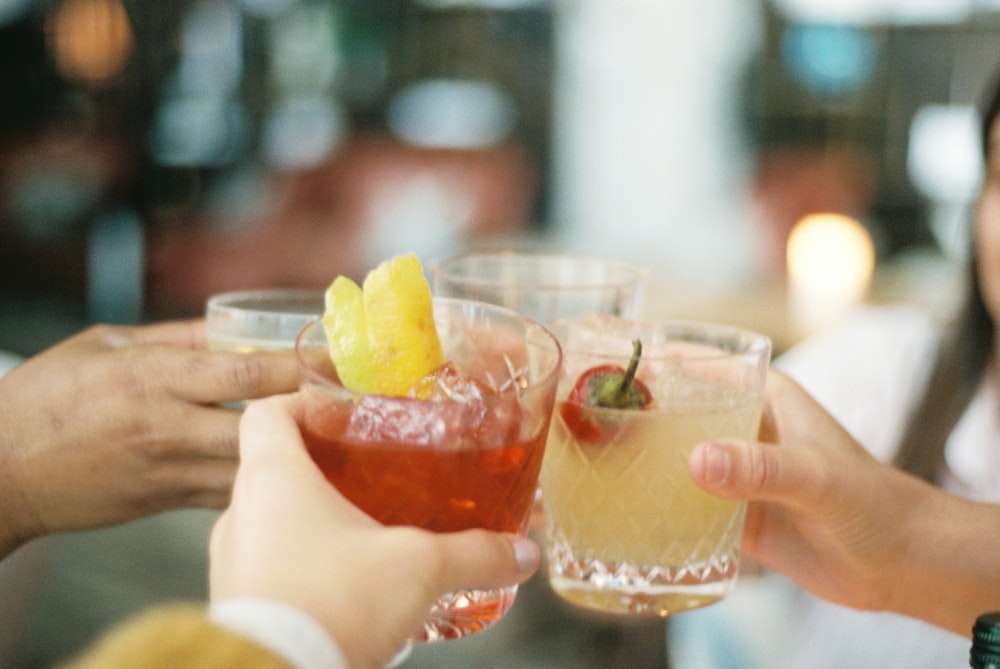 a group of people toasting with drinks