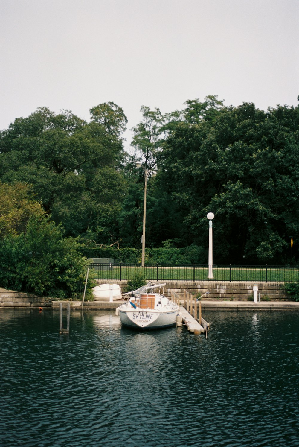 a small boat is docked at a dock