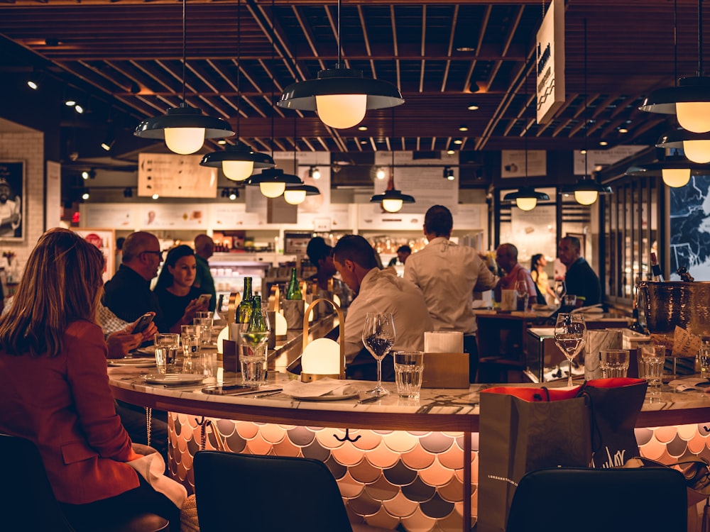 a group of people sitting at a table in a restaurant