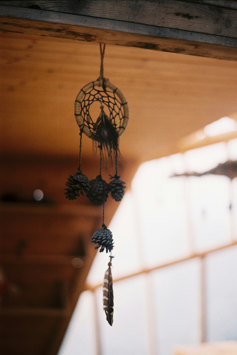 a wind chime hanging from a wooden ceiling