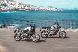two motorcycles parked next to each other in a parking lot