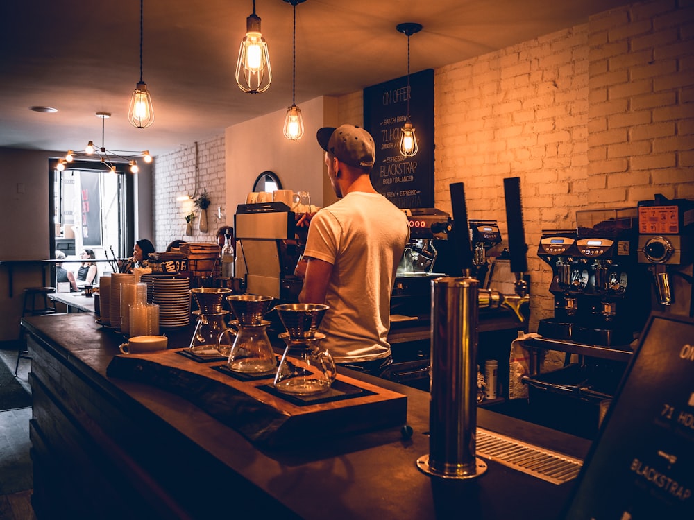 a man standing at a counter in a coffee shop