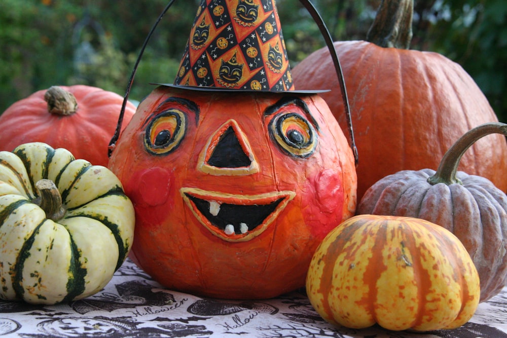 a group of pumpkins with faces painted on them