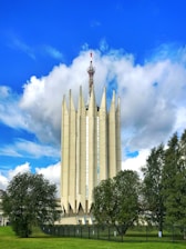 A modern data center building with secure fencing and green landscaping.