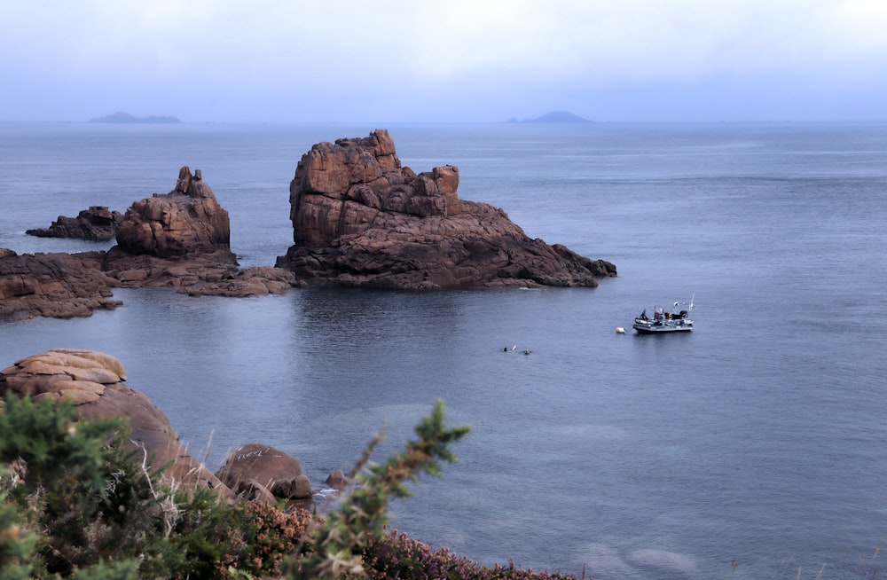 a small boat in the middle of a large body of water