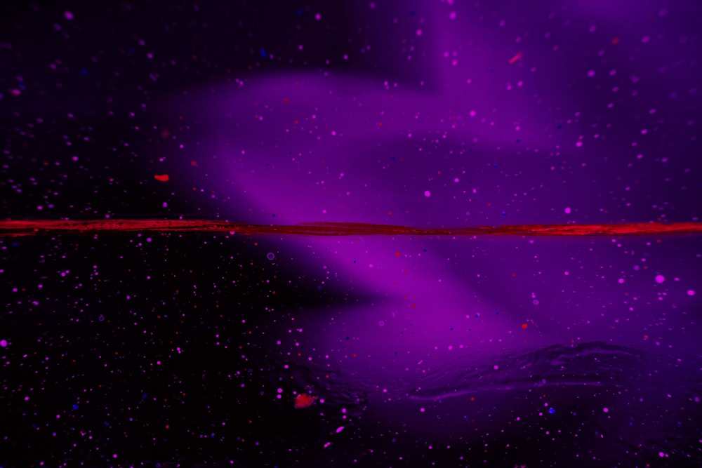 a purple and black background with a red line