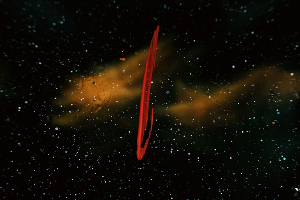 a close up of a red object on a black background