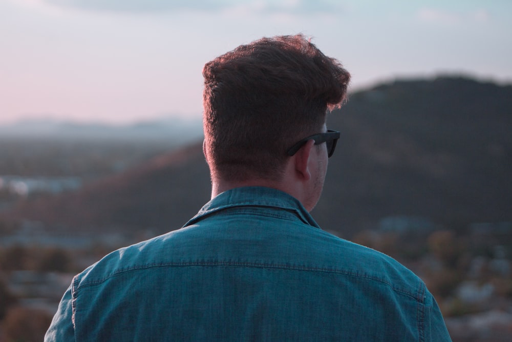 a man with sunglasses looking out over a city