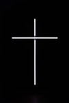 a cross that is lit up in the dark