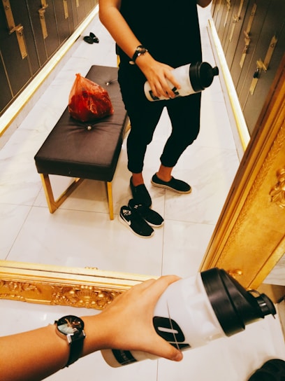 A candid shot of a creator mid-workout, dressed sharply, with grooming products and cologne nearby.