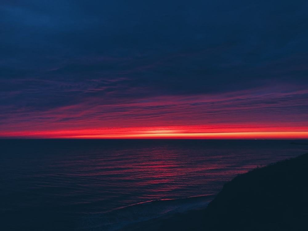 calm body of water during horizon