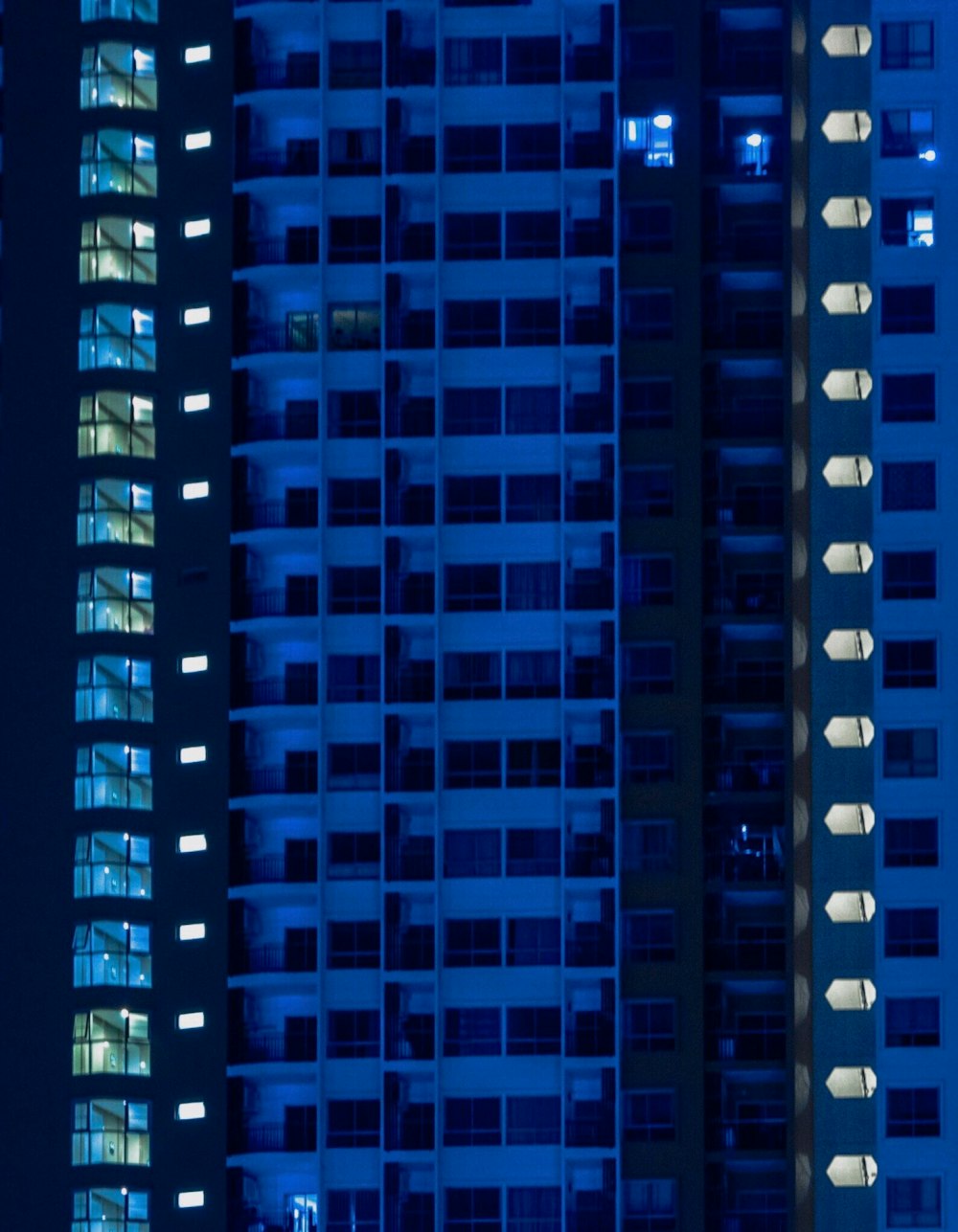 a tall building with many windows lit up at night