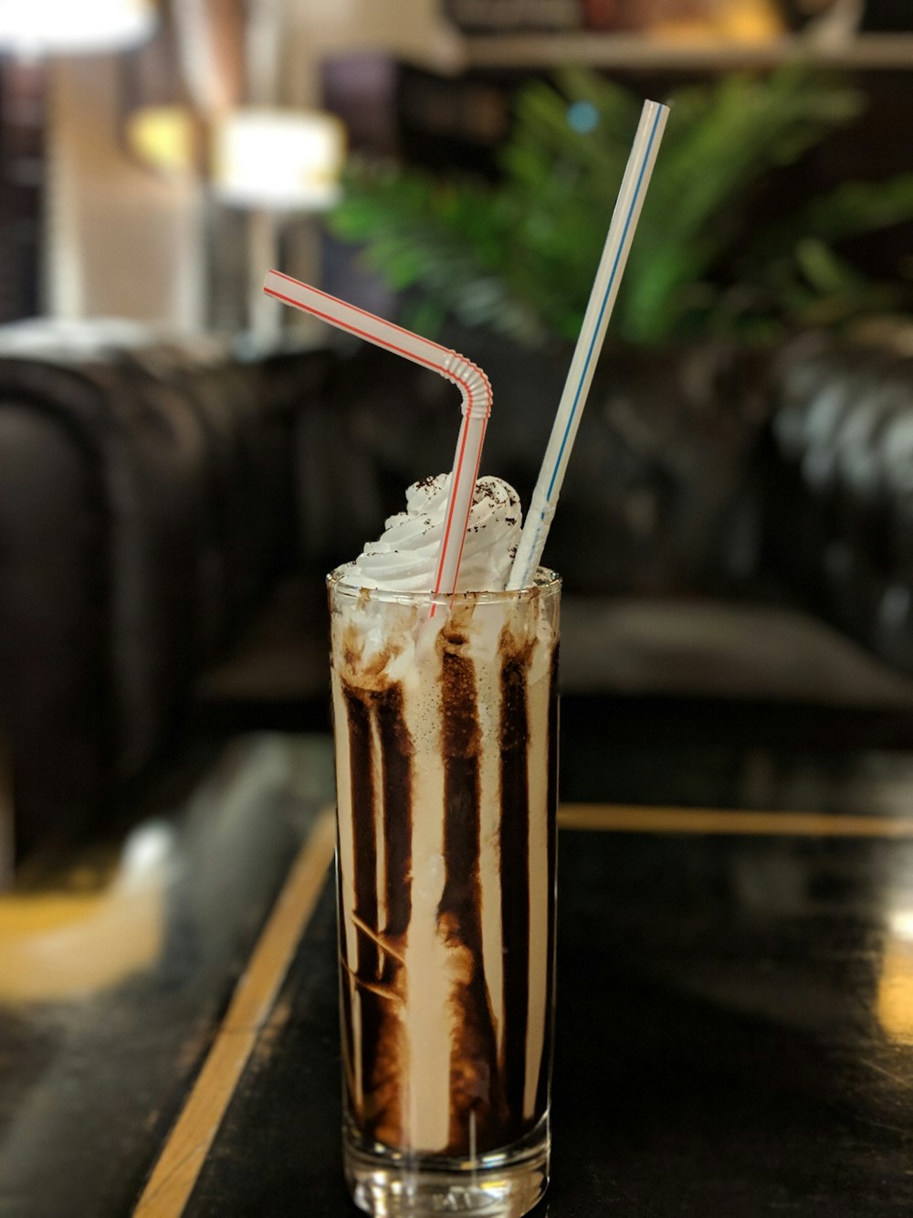 chocolate with cream on top and two straws