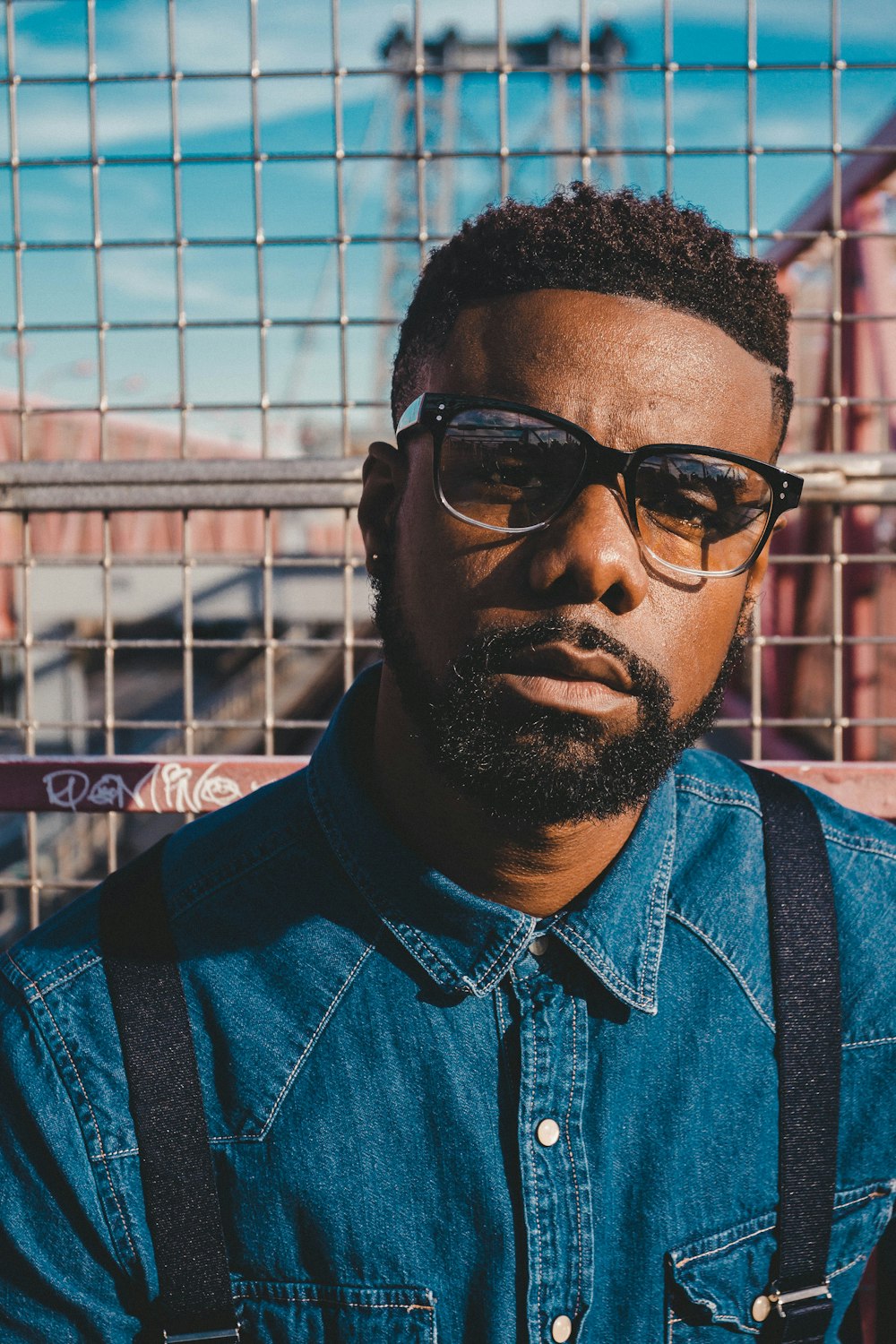 shallow focus photo of man wearing eyeglasses with black frames