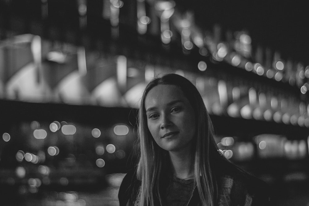 grayscale photography of woman wearing crew-neck shirt smiling