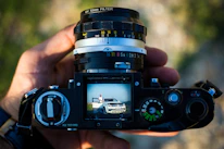 Close-up of hands photographing vehicle parts to send for video creation.
