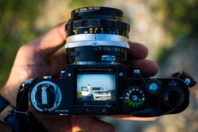 Close-up of hands photographing vehicle parts to send for video creation.