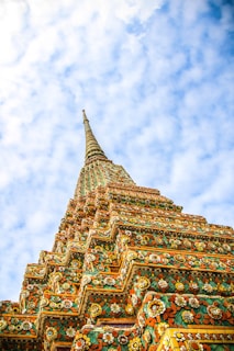low-angle photography of Wat Temple under white and blue sky during daytime