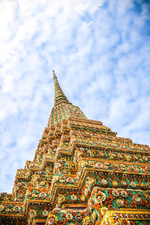 low-angle photography of Wat Temple under white and blue sky during daytime