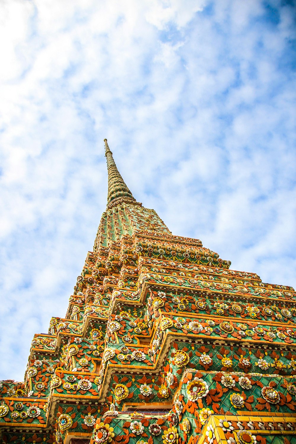 low-angle photography of Wat Temple under white and blue sky during daytime