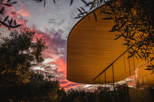 Sunset over a modern building completed through partnership projects.