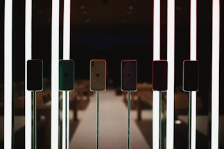 A sleek digital standee display glowing softly in a modern retail setting.