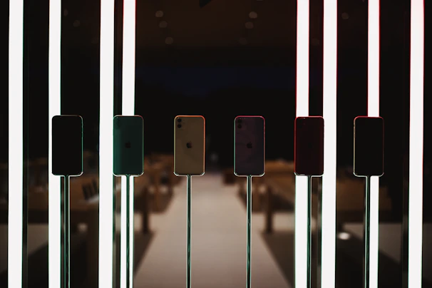 A vibrant display of the latest sleek smartphones glowing under soft colorful lights.